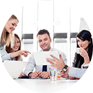 A group of people sitting around a table.